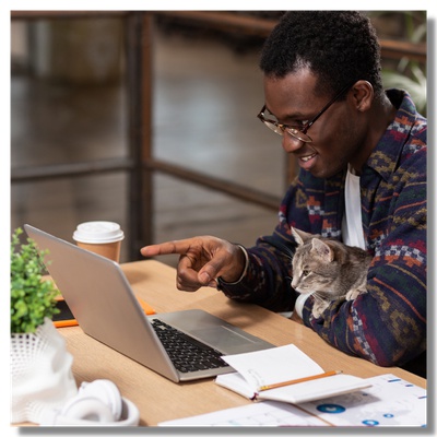 A man with a cat and laptop