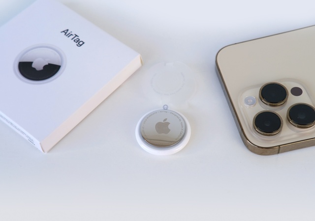 An AirTag next to an iPhone on the Find My application