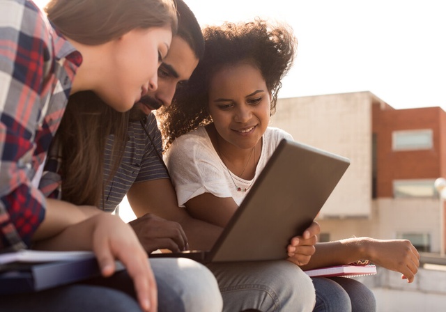 group of three people on the computer