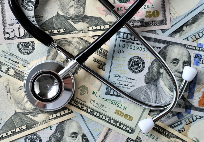 A stethoscope laying on money